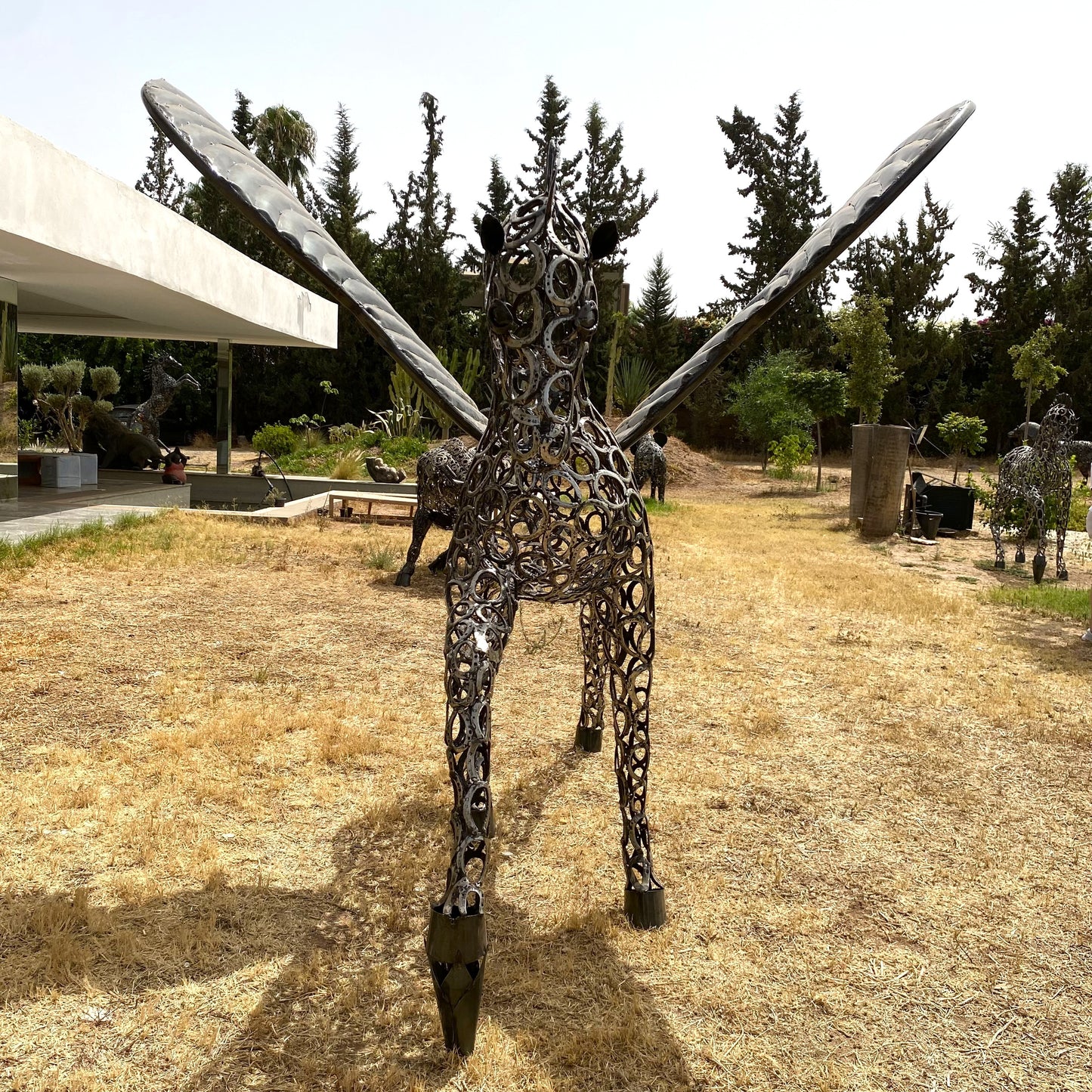 Sculpture cheval Pégase au trot en fer à cheval – H205 × L300 × l230 cm