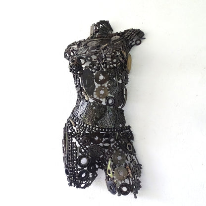 Sculpture demi-buste de femme en métal recyclé posée devant un mur de jardin, H77 x L42 cm, finition brute